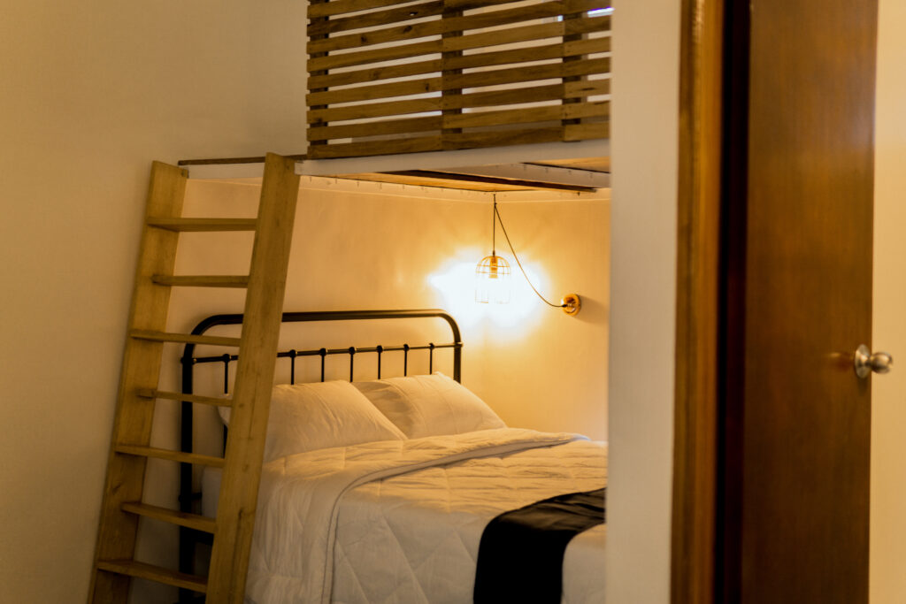 Deluxe Loft at Kahana Baler with a loft bed upstairs and pool access