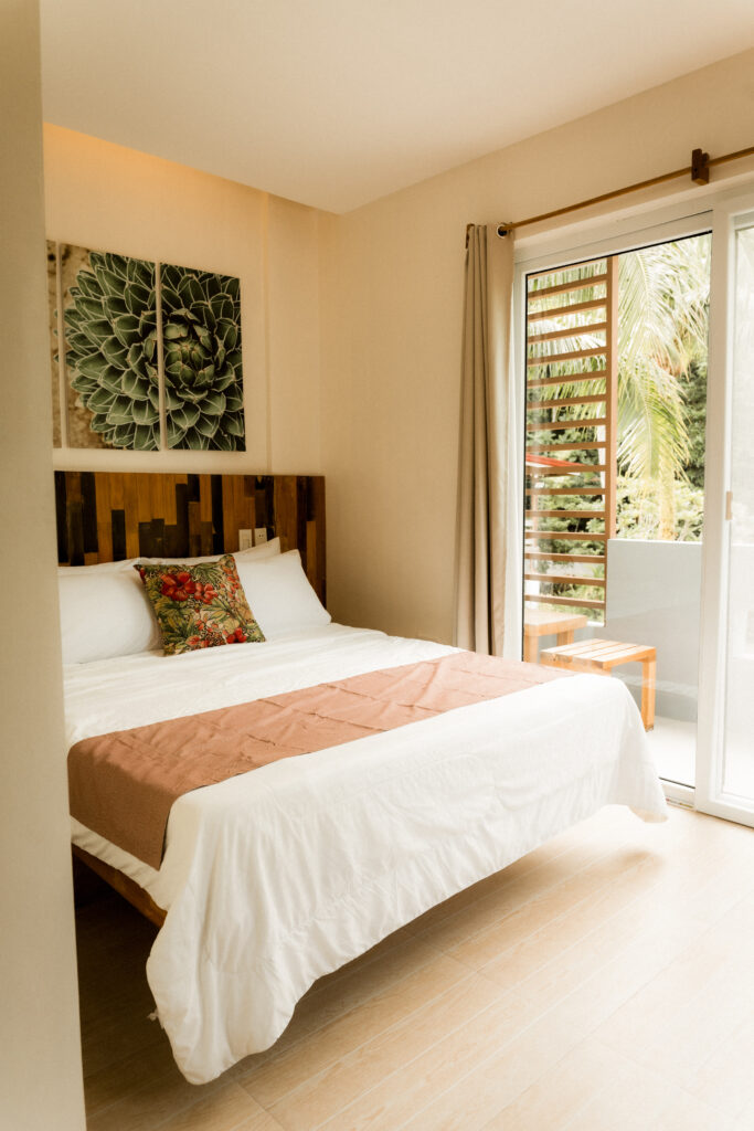 Premier Suite at Kahana Baler with a queen bed and balcony
