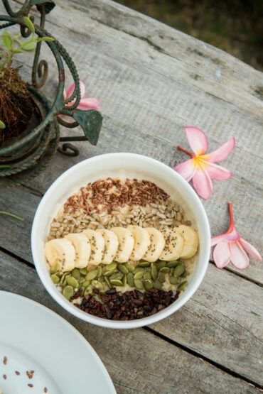Oatmeal bowl topped with banana, chia, pumpkin and sunflower seeds and cacao nibs, served at The Shala Grounds cafe at Kahana Baler